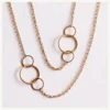 Lange goudkleurige schakelketting met ronde details
